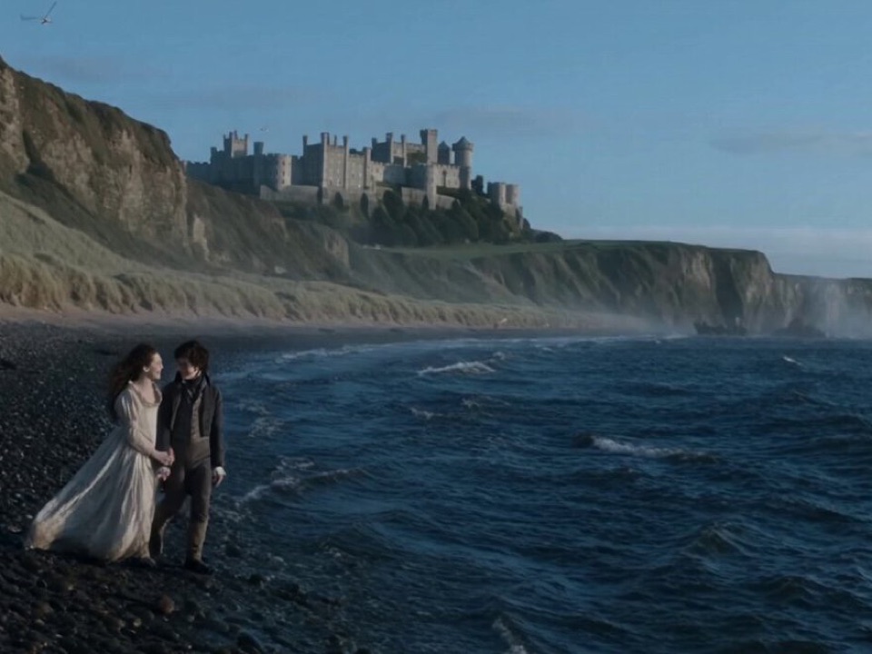 Seedance 2.5 cinematic frame of a couple on a coastal beach beneath a castle